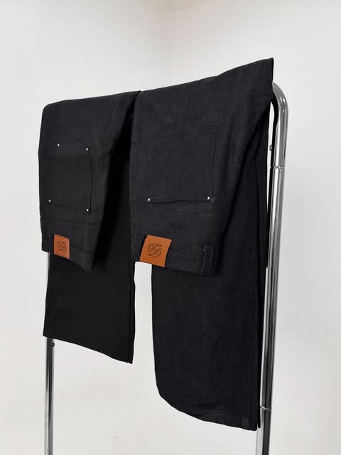 Dark denim hanging on a rack